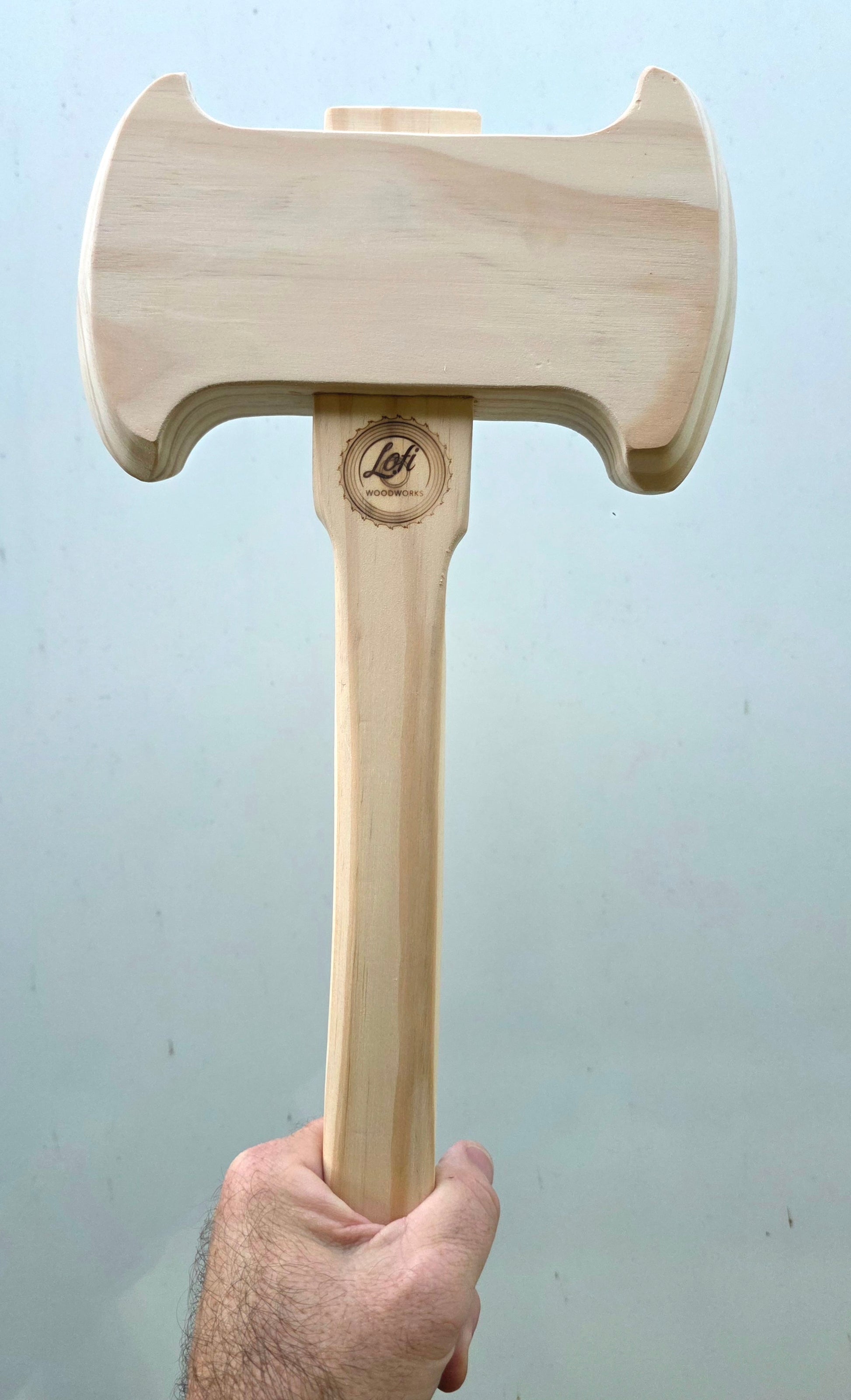 Wooden axe held by a hand made by Lofi Woodworks