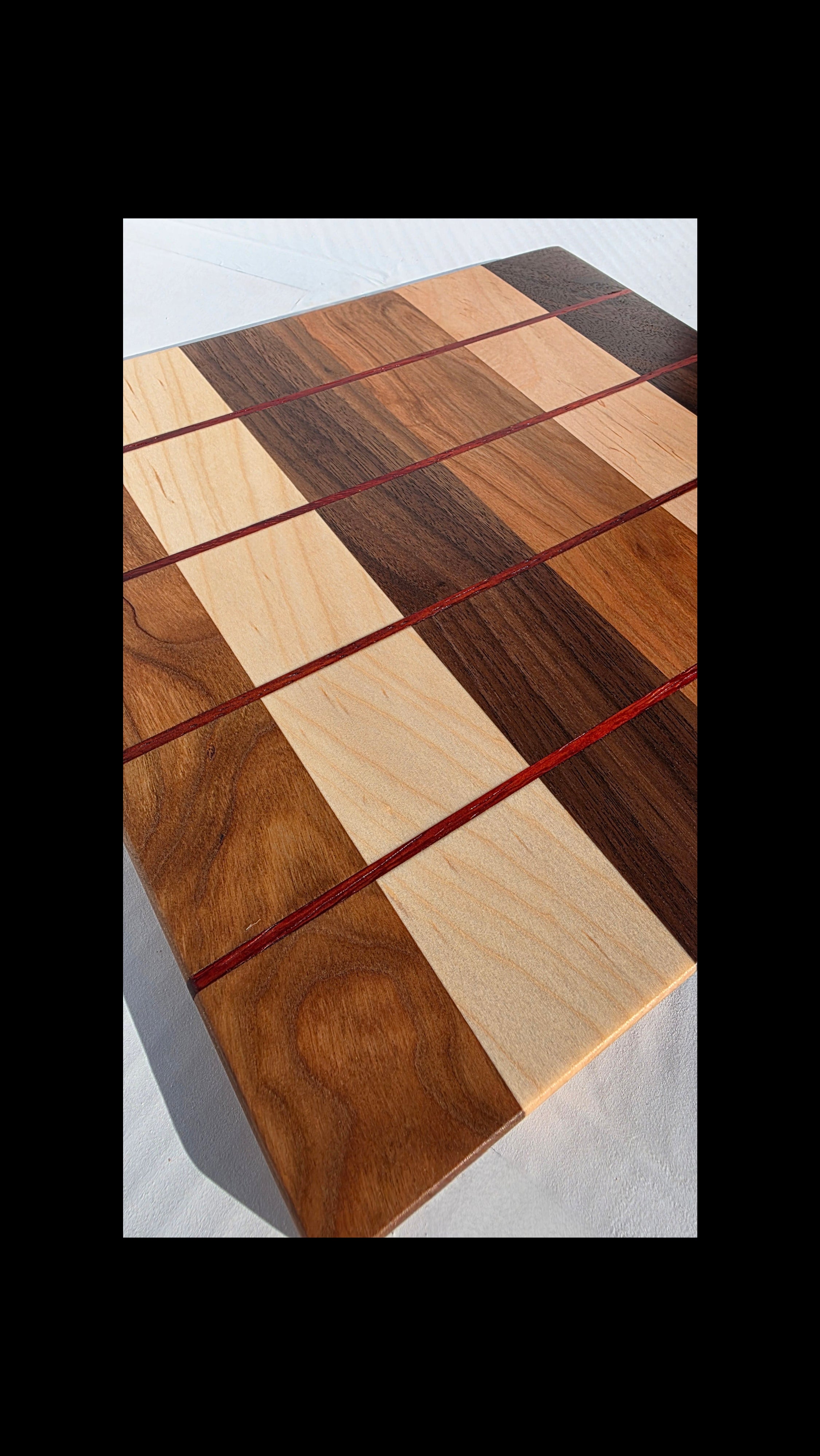 handcrafted serving board with multiple wood inlay 